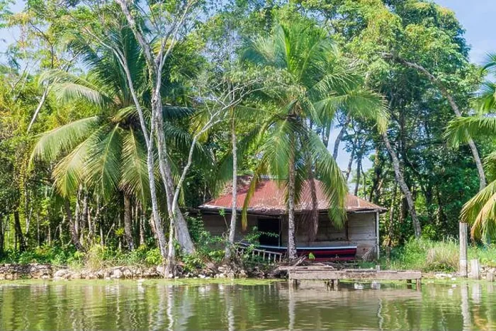 Framed Print : Small house at the coast of Rio Dulce river, Guatemala Framed Print : Small house at the coast of Rio Dulce river, Guatemala