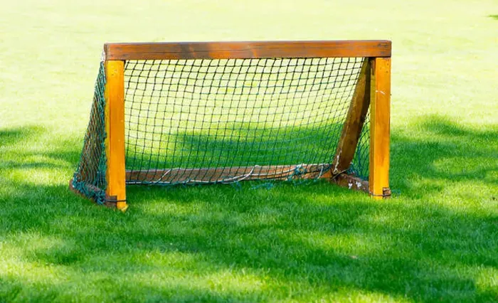 Framed Print : The small wooden goal for the soccer on the empty green field