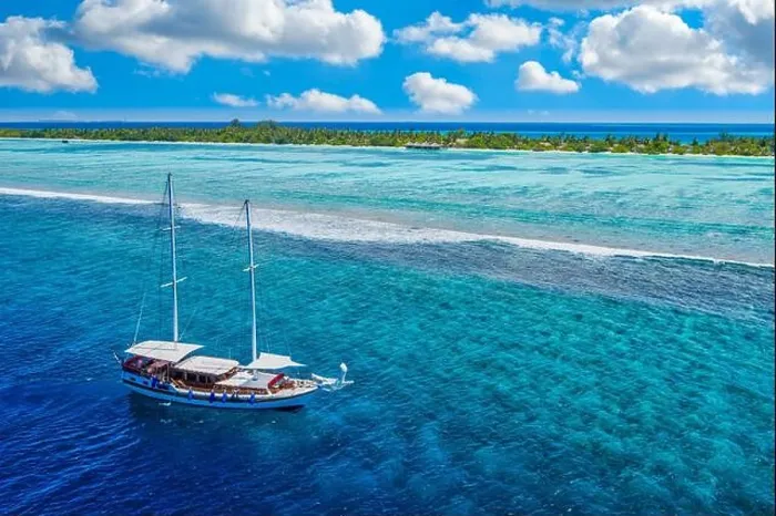 Framed Print : Small yacht sailing in tropical sea over coral reef in Indian ocean lagoon. Exotic island landscape, aerial view, tranquil nature scenic Framed Print : Small yacht sailing in tropical sea over coral reef in Indian ocean lagoon. Exotic island landscape, aerial view, tranquil nature scenic