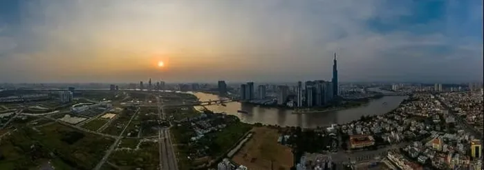 Framed Print : Smoggy Sunset Panorama over Saigon River in Ho Chi Minh City, Vietnam featuring the City Skyline