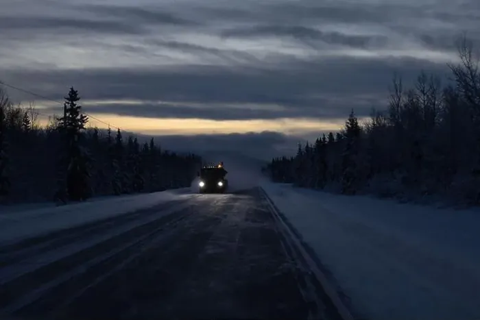 Framed Print : Snow blowing around truck driving on Richardson Highway on a dark winter morning in interior Alaska between Tok