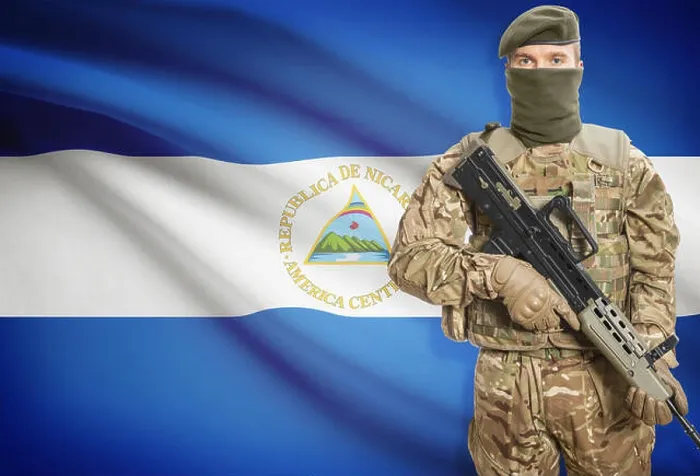 Framed Print : Soldier holding machine gun with national flag on background - Nicaragua Framed Print : Soldier holding machine gun with national flag on background - Nicaragua