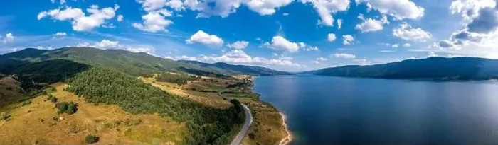 Framed Print : Spectacular aerial view from a drone to a lake, hills, and a road between Framed Print : Spectacular aerial view from a drone to a lake, hills, and a road between