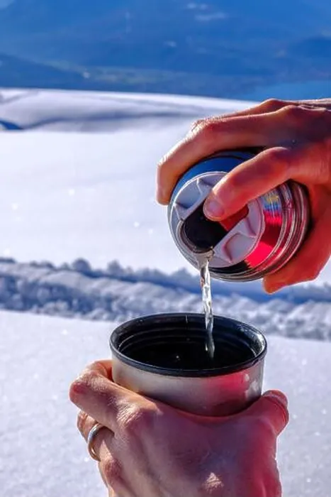Framed Print : Spilling tea from a flask on the top of a mountain on a snow covered landscape Framed Print : Spilling tea from a flask on the top of a mountain on a snow covered landscape