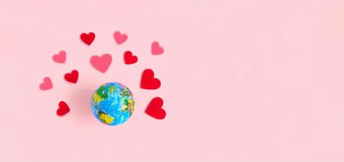 Framed Print : Spinning Earth with Hearts on beige pastel background Framed Print : Spinning Earth with Hearts on beige pastel background