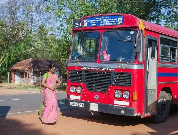 Framed Print : Sri Lankan female walks in front of red single decker bus before it departs Mullaitivu for Trincomalee, Sri Lanka Framed Print : Sri Lankan female walks in front of red single decker bus before it departs Mullaitivu for Trincomalee, Sri Lanka