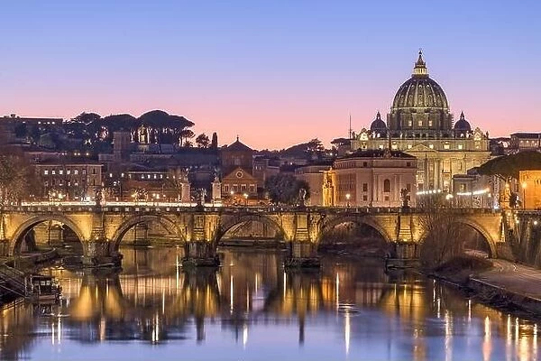 St. Peter's Basilica in Vatican City with the Tiber River passing through Rome, Italy at dusk