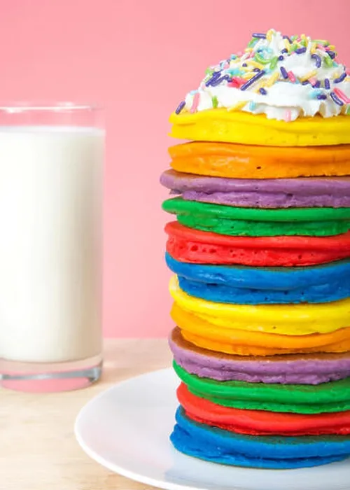 Framed Print : Stack of bright colorful pancakes topped with whipped cream and candy sprinkles with pink background and glass of milk Framed Print : Stack of bright colorful pancakes topped with whipped cream and candy sprinkles with pink background and glass of milk
