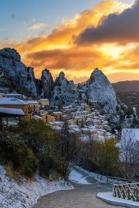 Framed Print : Steep road leads down into Castlemzzano village in winter with a colourful sunrise sky above Framed Print : Steep road leads down into Castlemzzano village in winter with a colourful sunrise sky above