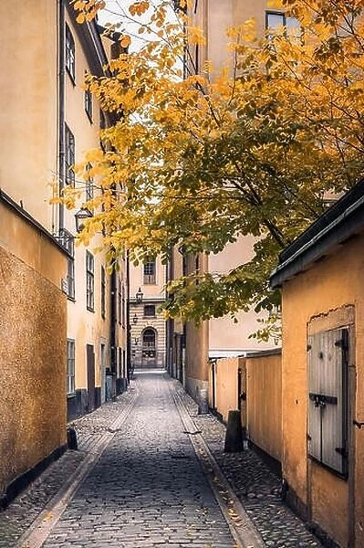 STOCKHOLM, SWEDEN - October 14, 2016: View from narrow and idyllic street with colorful buildings in Gamla Stan. The Old Town in Stockholm, Sweden. Cl