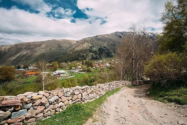 Stone Fence Along A Countryside Road Near Sioni Village In Kazbegi District, Mtskheta-mtianeti Region, Georgia. Spring Or Summer Season