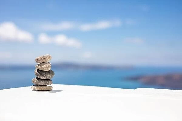 Stones balance, pebbles stack on seascape view. Relaxing concept, white and blue colors