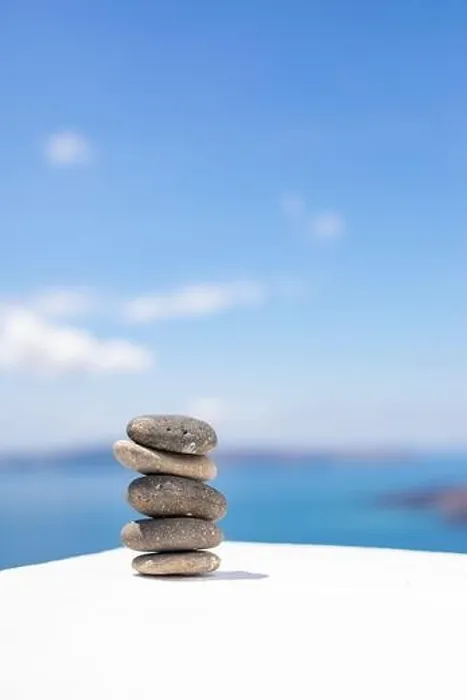 Framed Print : Stones balance, pebbles stack on seascape view. Relaxing concept, white and blue colors Framed Print : Stones balance, pebbles stack on seascape view. Relaxing concept, white and blue colors