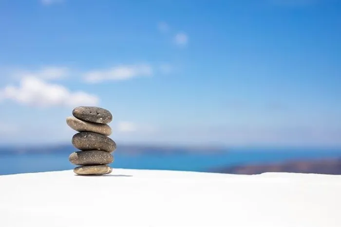 Framed Print : Stones balance, pebbles stack on seascape view. Relaxing concept, white and blue colors Framed Print : Stones balance, pebbles stack on seascape view. Relaxing concept, white and blue colors