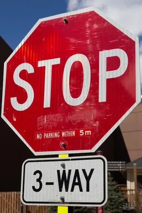 Framed Print : A stop sign on a street in Banff, Alberta, Canada. Parking is restricted around the three way junction Framed Print : A stop sign on a street in Banff, Alberta, Canada. Parking is restricted around the three way junction