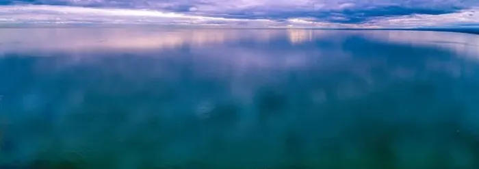 Framed Print : Storm low clouds reflecting in smooth and calm ocean water - aerial panoramic seascape Framed Print : Storm low clouds reflecting in smooth and calm ocean water - aerial panoramic seascape