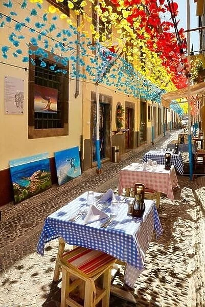 Street decorated with paper flowers on feast of Madeira, Funchal old town, Madeira Island, Portugal