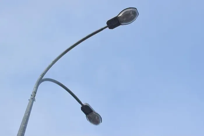 Framed Print : Street light with halogen lamp against blue sky Framed Print : Street light with halogen lamp against blue sky