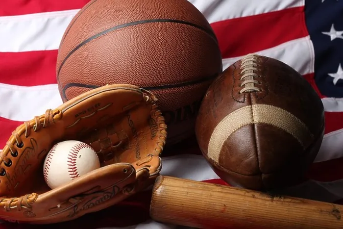 Framed Print : A studio shot of an American Football, a basketball and a baseball ball, mitt and bat Framed Print : A studio shot of an American Football, a basketball and a baseball ball, mitt and bat