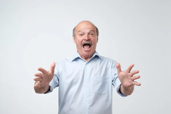 Framed Print : Studio shot of mature hispanic man against gray background. I can not belive what are you saying Framed Print : Studio shot of mature hispanic man against gray background. I can not belive what are you saying
