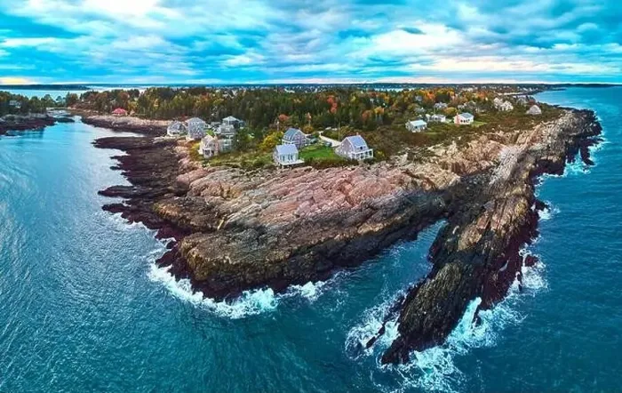 Framed Print : Stunning aerial over rocky coasts of Maine on the ocean with houses, fall foliage, and dusk light Framed Print : Stunning aerial over rocky coasts of Maine on the ocean with houses, fall foliage, and dusk light