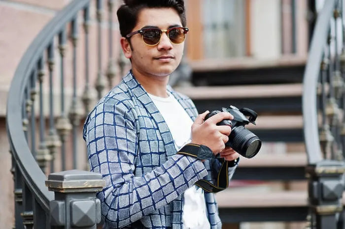 Framed Print : Stylish indian young man photographer at sunglasses wear casual posed outdoor against iron stairs with dslr photo Framed Print : Stylish indian young man photographer at sunglasses wear casual posed outdoor against iron stairs with dslr photo
