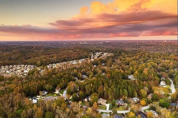 Suburban neighborhoods viewed from above during an autumn dusk