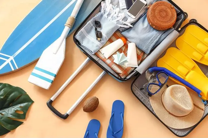 Framed Print : Suitcase with clothes, beach accessories and surfboard on beige background. Travel concept Framed Print : Suitcase with clothes, beach accessories and surfboard on beige background. Travel concept