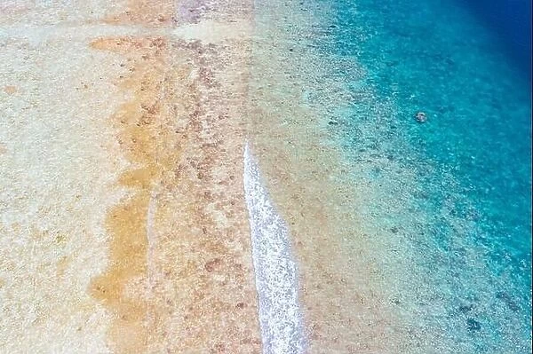 Summer aerial photo of beach with ocean and free space for your decoration. Tropical sea and lagoon in Indian ocean, soft waves splashing, aerial view