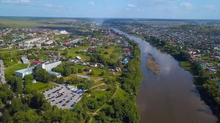 Framed Print : Summer aerial view. Clip. A large dirty river flowing around the forest and small residential buildings are visible Framed Print : Summer aerial view. Clip. A large dirty river flowing around the forest and small residential buildings are visible