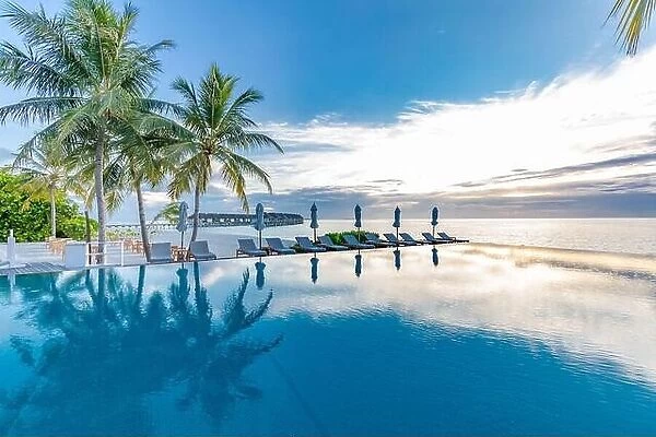 Summer beach swimming pool on sunny day with reflection of palm trees, tropical landscape, exotic island hotel resort concept. Luxury infinity pool