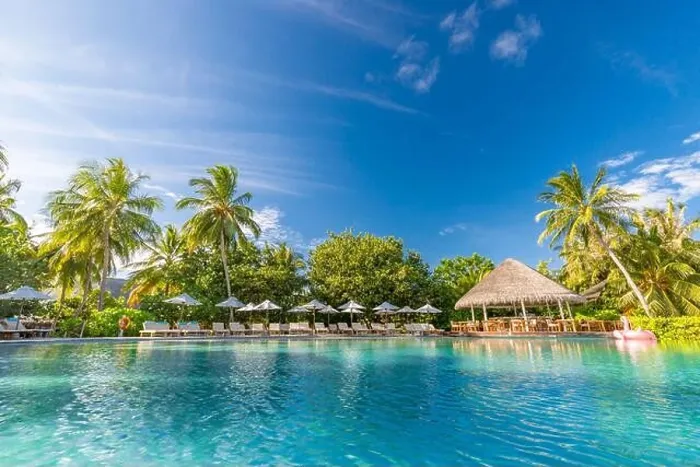 Framed Print : Summer outdoor tourism landscape. Luxurious beach resort with swimming pool and beach chairs or loungers under umbrellas with palm trees and blue sky Framed Print : Summer outdoor tourism landscape. Luxurious beach resort with swimming pool and beach chairs or loungers under umbrellas with palm trees and blue sky