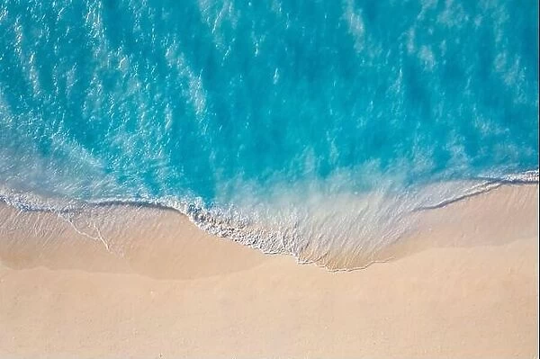 Summer seascape beautiful waves, blue sea water in sunny day. Top view from drone. Sea aerial view, amazing tropical nature background, seaside shore