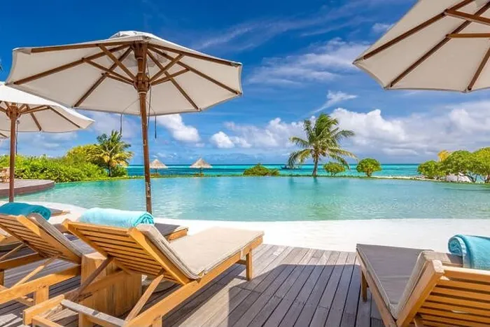 Framed Print : Summer tourism landscape. Luxurious beach resort with swimming pool and beach chairs or loungers under umbrellas infinity pool palm trees, blue sky
