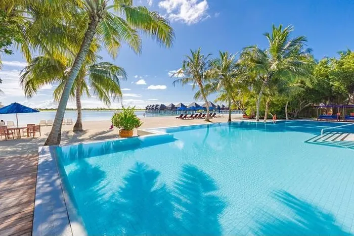 Framed Print : Summer tourism landscape. Luxurious beach resort with swimming pool and beach chairs or loungers under umbrellas with palm trees and blue sky, relax Framed Print : Summer tourism landscape. Luxurious beach resort with swimming pool and beach chairs or loungers under umbrellas with palm trees and blue sky, relax