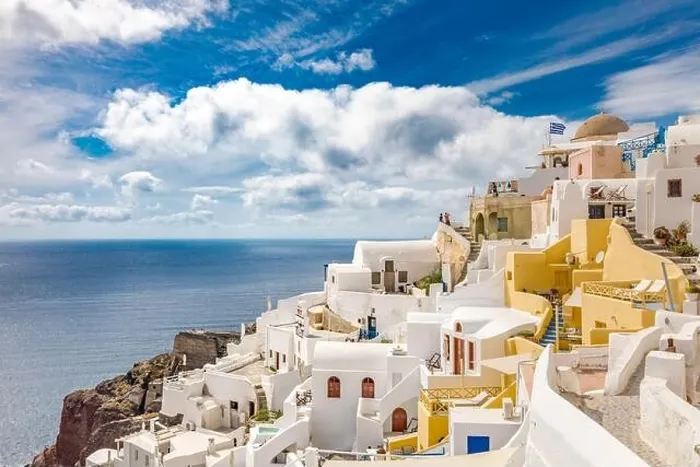 Framed Print : Summer travel destinations. Picturesque cityscape of Oia village in Santorini island located volcanic caldera. Traditional windmills, luxury vacation
