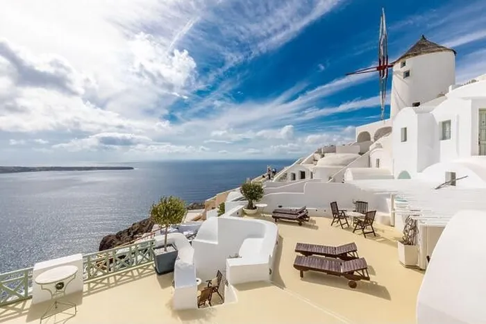 Framed Print : Summer travel destinations. Picturesque cityscape of Oia village in Santorini island located volcanic caldera. Traditional windmills, luxury vacation Framed Print : Summer travel destinations. Picturesque cityscape of Oia village in Santorini island located volcanic caldera. Traditional windmills, luxury vacation