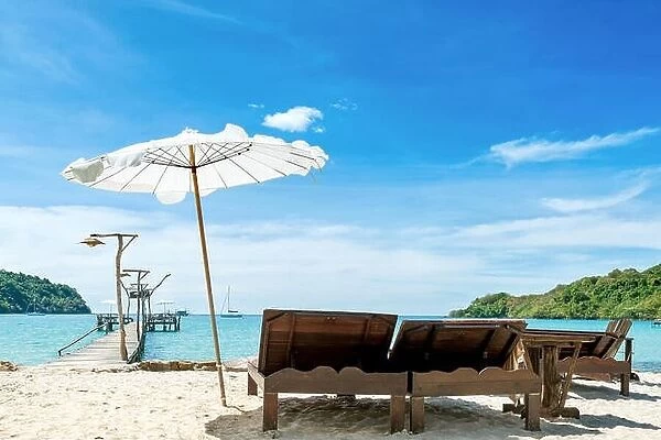 Summer, Travel, Vacation and Holiday concept - Beach chairs with umbrella and beautiful sand beach on hotel beach lounge