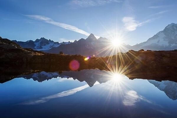 Sun rising on Chesery lake (Lac De Cheserys) in France Alps. Monte Bianco mountain range on background. Landscape photography, Chamonix