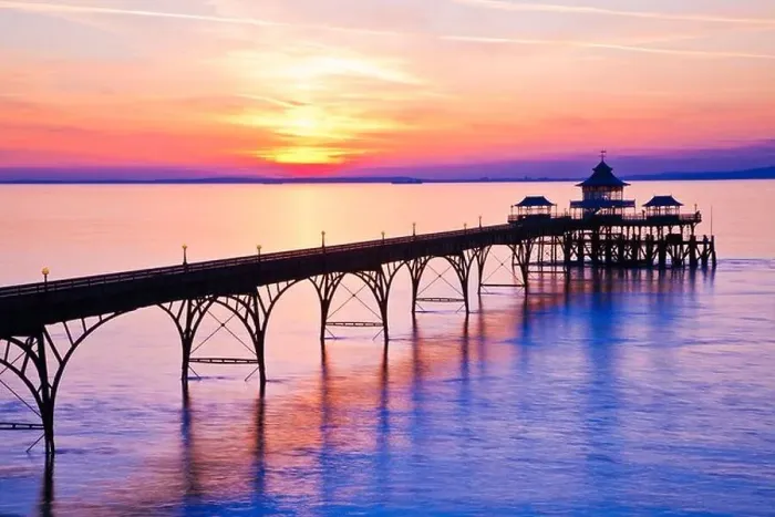 Framed Print : The sun sets over the Bristol Channel behind the Pier at Clevedon, Somerset, England, UK Framed Print : The sun sets over the Bristol Channel behind the Pier at Clevedon, Somerset, England, UK