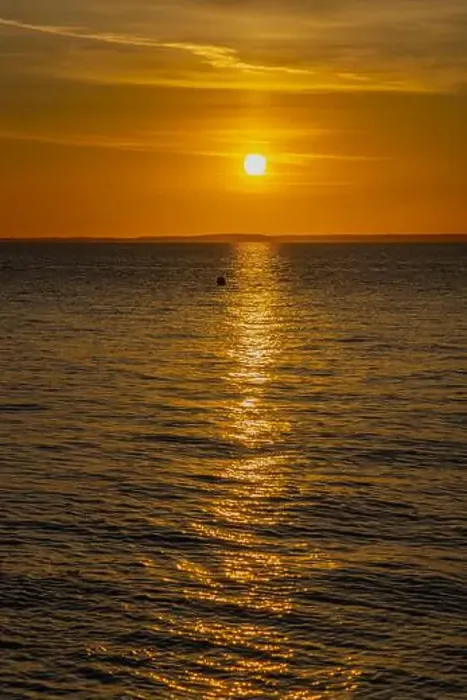 Framed Print : The sun setting over the Welsh coast sending a streak of Sunlight across the sea Framed Print : The sun setting over the Welsh coast sending a streak of Sunlight across the sea
