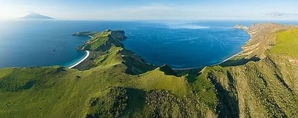 Sunlight illuminates the beautiful coastline of an island near Komodo in Indonesia. This region is known for its spectacular marine biodiversity