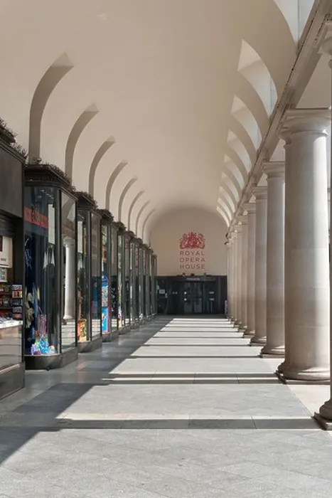 Framed Print : sunlit walkway under and trough shop lined fronts and columns to entrance Royal Opera House