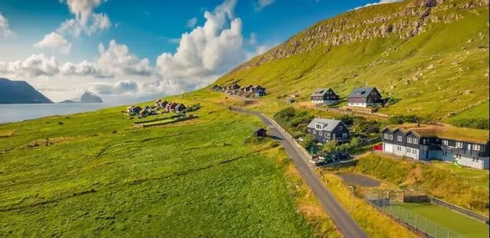 Framed Print : Sunny summer view from flying droneof Kirkjubour village with Hestur Island on background Framed Print : Sunny summer view from flying droneof Kirkjubour village with Hestur Island on background