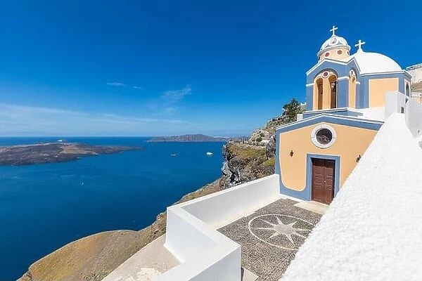Sunny travel landscape, belltower of a church with a view of Santorini volcanic caldera and ships in it, Santorini, Cyclades, Greece
