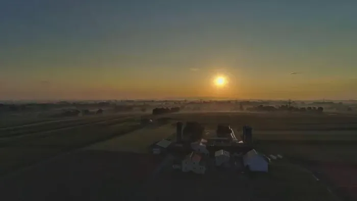 Framed Print : Sunrise over barns, silos and green farmlands with blue, red and orange skies and a few clouds with a mist on the ground Framed Print : Sunrise over barns, silos and green farmlands with blue, red and orange skies and a few clouds with a mist on the ground