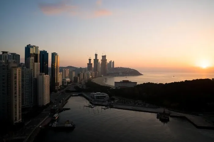 Framed Print : Sunrise at Haeundae beach in Busan. Haeundae beach is Busan's most popular beach in South Korea Framed Print : Sunrise at Haeundae beach in Busan. Haeundae beach is Busan's most popular beach in South Korea