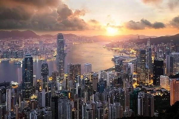 Sunrise over Hong Kong Victoria Harbor from Victoria Peak with Hong Kong and Kowloon below. Asian tourism, modern city life, or business finance and e