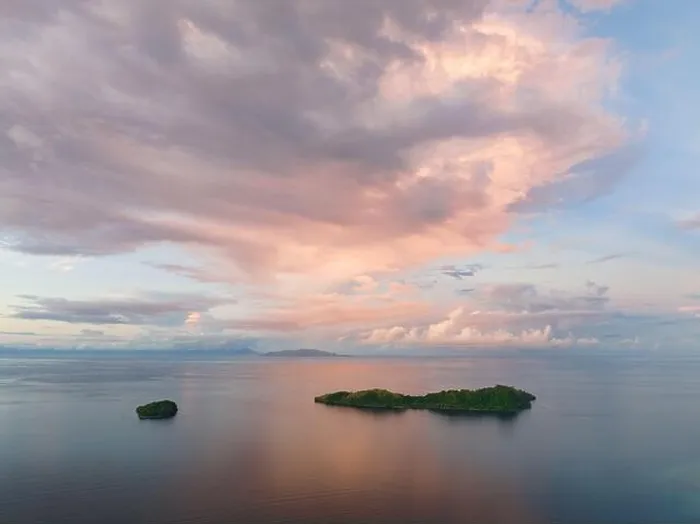 Framed Print : Sunrise illuminates clouds that drift over the calm waters of the Solomon Islands. This scenic region is known for its high marine biodiversity Framed Print : Sunrise illuminates clouds that drift over the calm waters of the Solomon Islands. This scenic region is known for its high marine biodiversity