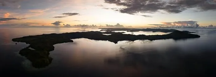 Framed Print : Sunrise illuminates clouds that drift over the calm waters of the Solomon Islands. This scenic region is known for its high marine biodiversity Framed Print : Sunrise illuminates clouds that drift over the calm waters of the Solomon Islands. This scenic region is known for its high marine biodiversity